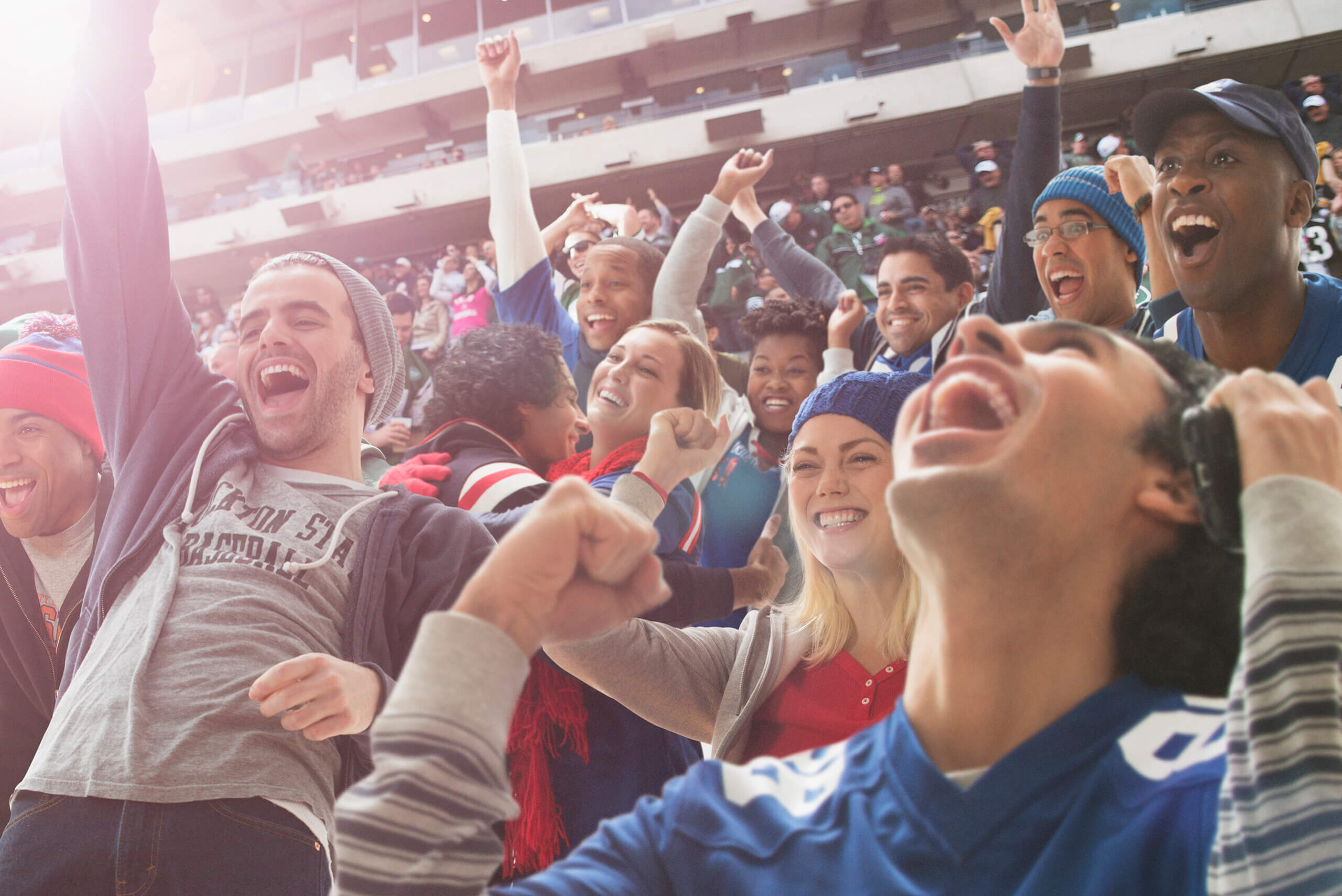 Football fans cheering in a stadium setting